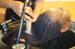 client having hair washed in a salon