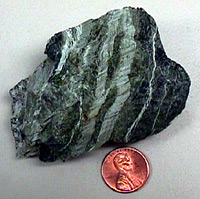 Photo of serpentine rock with veins of asbestos.