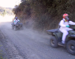 4-wheel all-terrain vehicle riders wearing protective clothing and breathing canisters