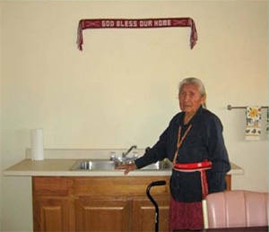 A tribal elder in her home