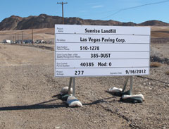 This sign lists temporary telephone contacts for Las Vegas Paving Company during the construction phase of the closure operation