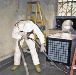 Person in Hazmat suit removing lead paint.
