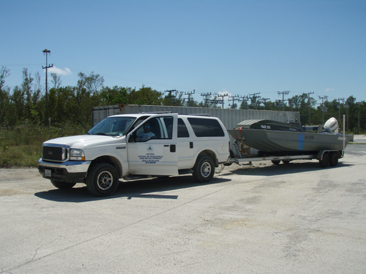 White truck trailering a boat