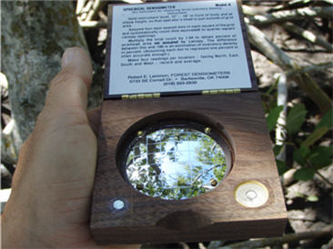 photo of a "densiometer" showing the grided convex mirror used to quantify the amount of shade cover in the tree canopy.