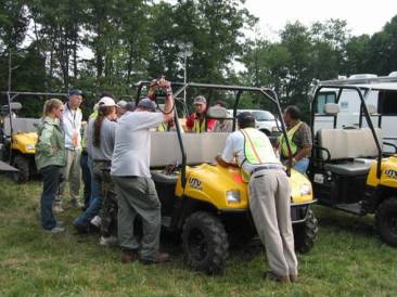 EPA staff gathered around gator