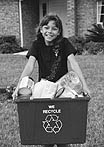 girl carrying recycling bin to the curb