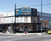 Photo of shops with recycling bins on the street