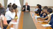 Former administrator Johnson at a conference table with Howard University students